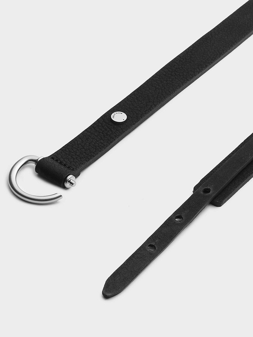 Sentence with Product Name: rag & bone Clarke Hip Belt in Black Italian vegetable tanned leather belt with silver buckle, isolated on a white background.