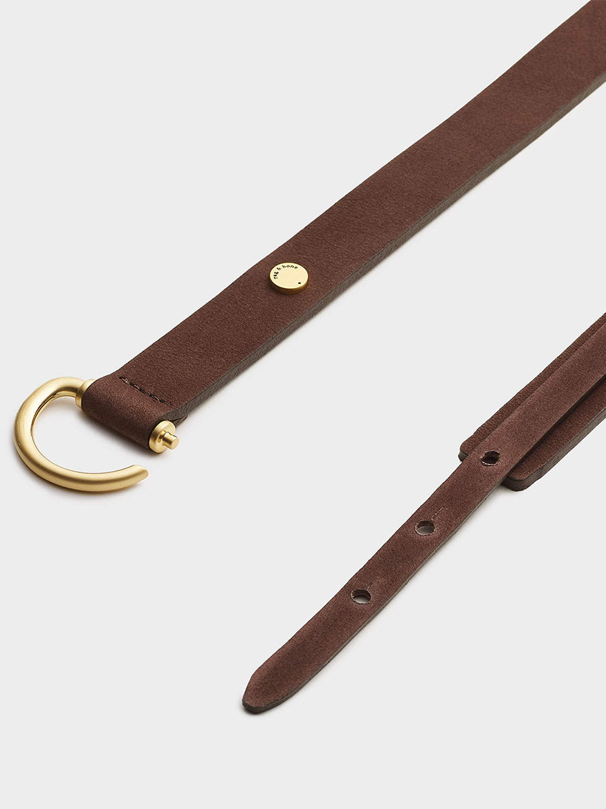 Sentence with replacement: Clarke Hip Belt in Matter Brown with a gold-tone hook buckle, Made in England.