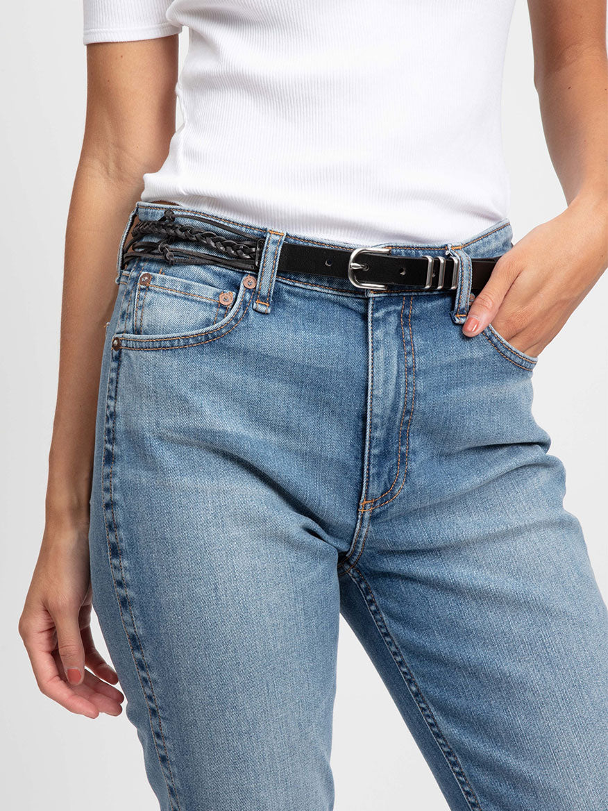 A woman wearing jeans and a rag & bone Knotted Jet Belt in Black with knotted detailing.